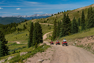 a man riding a bike down a dirt road