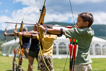 a young boy holding a kite