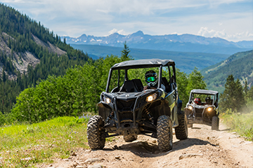 a truck driving down a dirt road