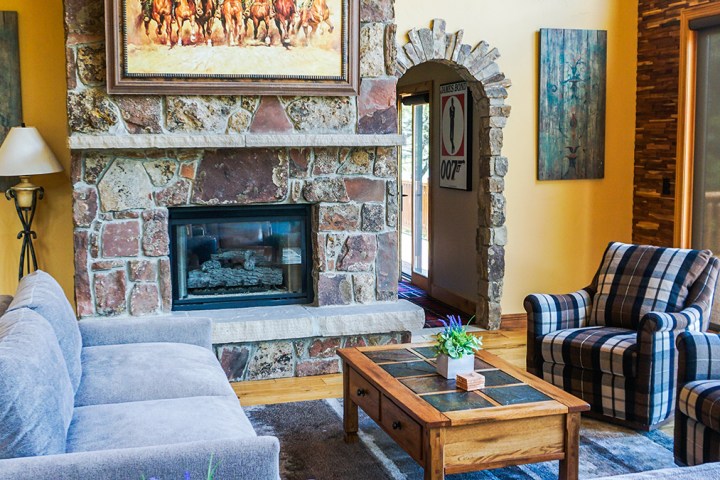 a living room filled with furniture and a fire place